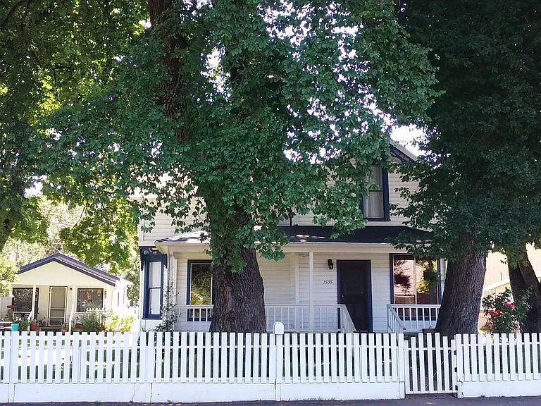 This is the front view of the property with the cottage to the left and behind the house. Next to the cottage is parking for 3 cars and then the studio is behind and to the south of the house