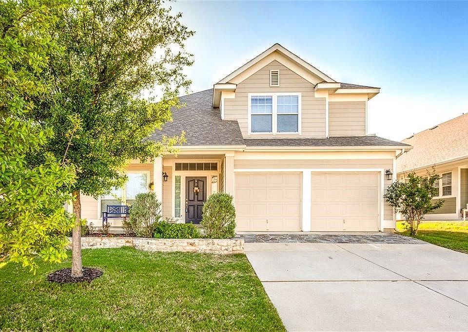 Rocking chair front porch & charming craftsman style with stone planters and walk.