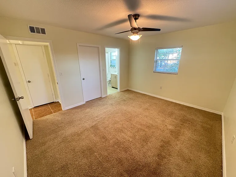 Master bedroom feels bright and airy thanks to two well-placed windows that let in plenty of natural light. It also includes a private ensuite bathroom.