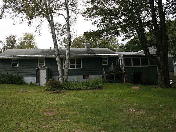 back of house with screened porch and walkout basement access