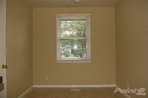 The eat in area of the kitchen has a ceiling fan and tile floors and can be easily accessed from the