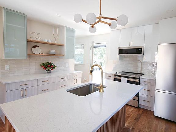 A kitchen for entertaining guests with a good sized deck out the back door.