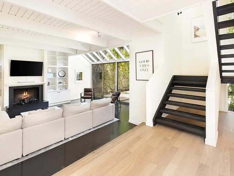 Sit back and relax on the designer couch in front of the fireplace and flat screen TV
