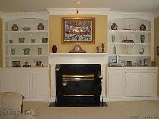handsome Built-Ins flank Gas-Log Fireplace in Den