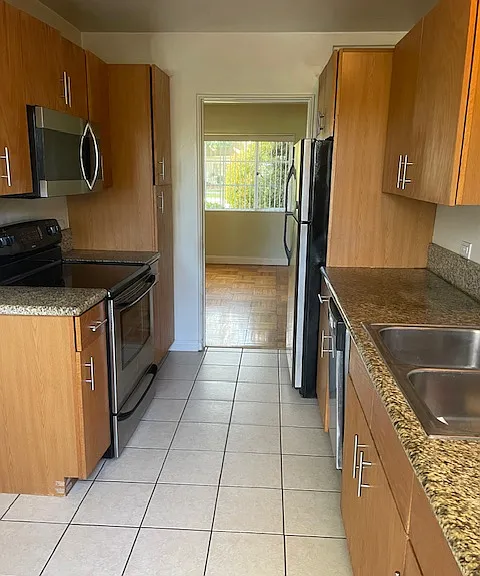 Galley kitchen fits cafe table and two chairs