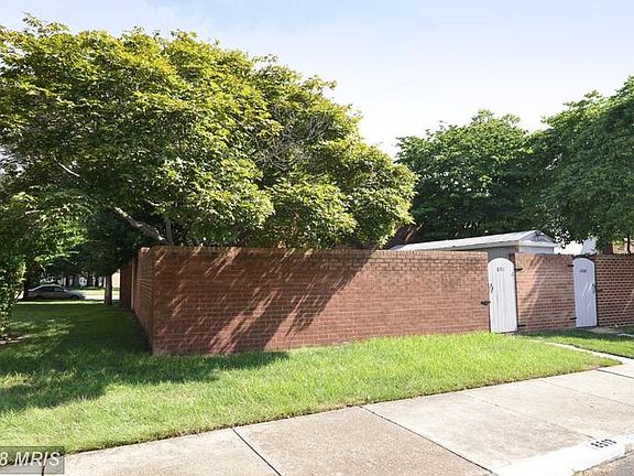 Brick wall surrounds backyard