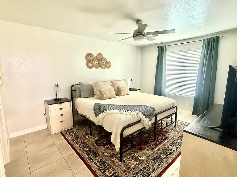 King Bedroom 1 with dresser, TV, walk in closet
