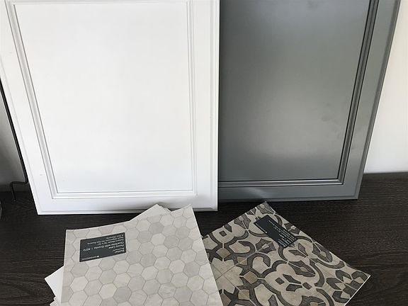 Kitchen cabinets will be crisp white and bathrooms this rich grey. Bathrooms floors will be either