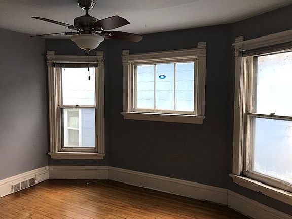 Bedroom with original trim and new windows.