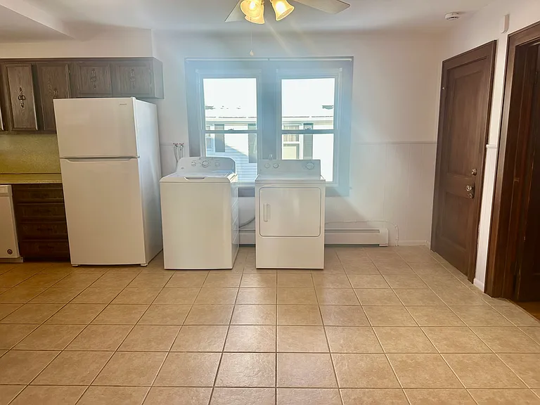 Kitchen with full sized washer and dryer