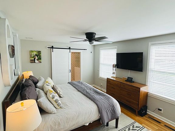 Master bedroom with barn doors to bathroom and walk in closet