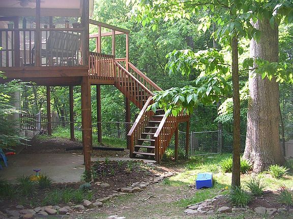backyard view of screened porch and deck