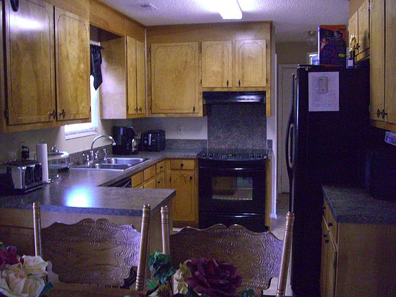 The spacious kitchen has an eatin dining area
