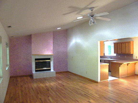 View from front entrance looking at living room and kitchen. Three solar tubes bring natural light into living room. Fan can circulate air.