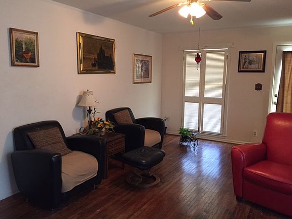 Adorable living area with nice hardwood floors and a ceiling fan!