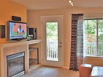 living area with fireplace and balcony
