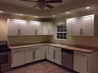 Kitchen with tray ceiling, fan and down lights, dishwasher,