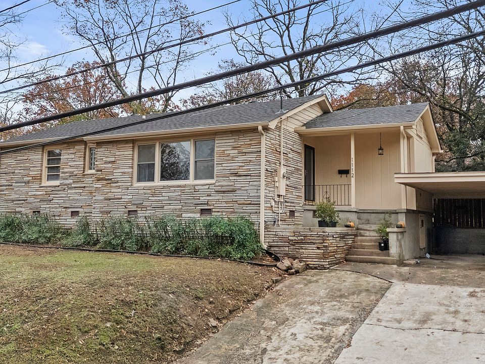 Front of house with carport on right.