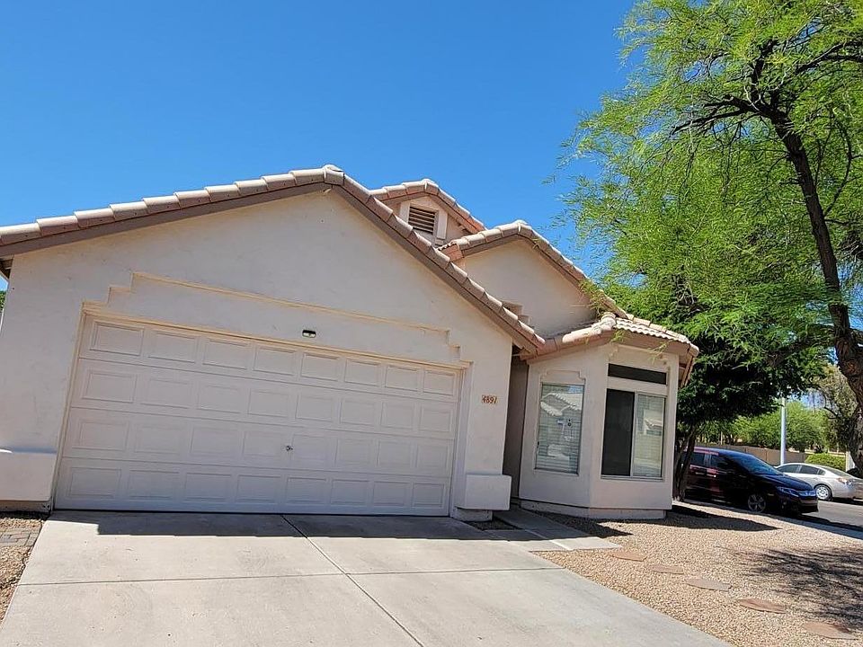 Drive way with 2 car garage. Paved path to the side yard.