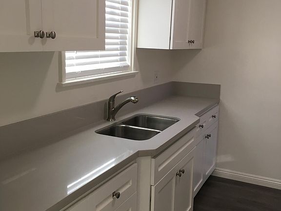Kitchen: New spacious cabinets with self-close doors and drawers. New quartz countertop. New window and faux blinds. New sink, garbage disposal and fixture. New Range and Microwave. New vinyl plank floors.