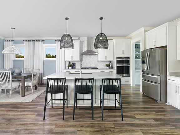 Prepare or serve meals from your new home gourmet kitchen that includes a large island. - Model Repr