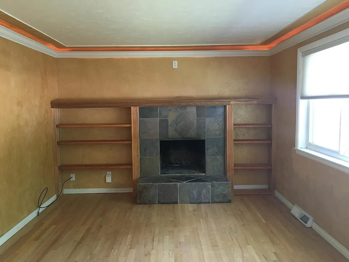 Living room with fire place and lighted crown molding - 8773 Princeton St