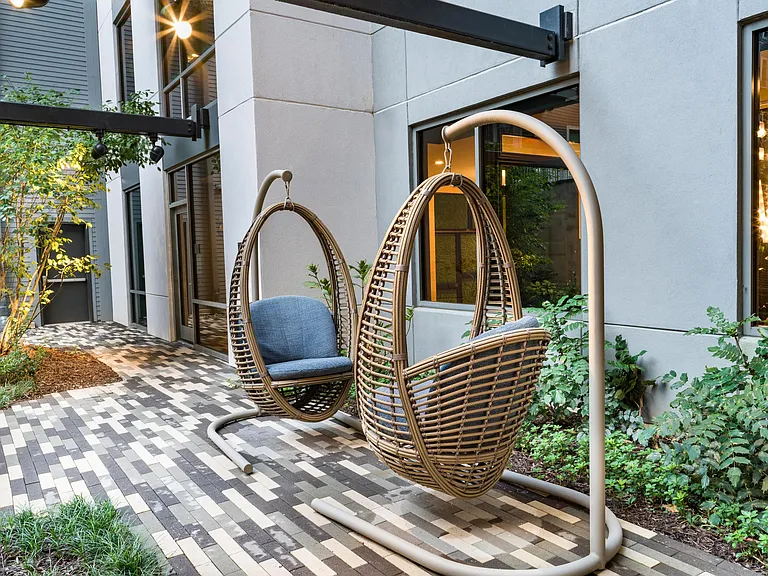 Unwind in the zen garden at Modera Old Ivy, where suspended loungers and thoughtful design create a quiet retreat near Buckhead.