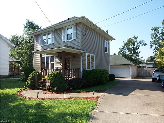 View showing covered front porch and DBL detached garage.   Great curb appeal.