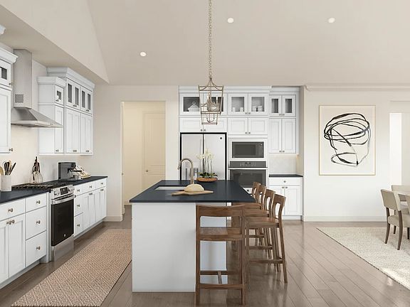 Pendant lighting and gorgeous countertops in kitchen