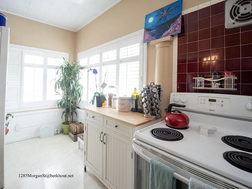 Big windows give great light in the kitchen.
The range pictured has been replaced with a modern induction stove.