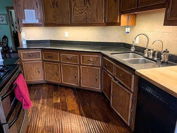 granite countertops, stainless steel sink, all wood cupboards and hand scraped teak flooring