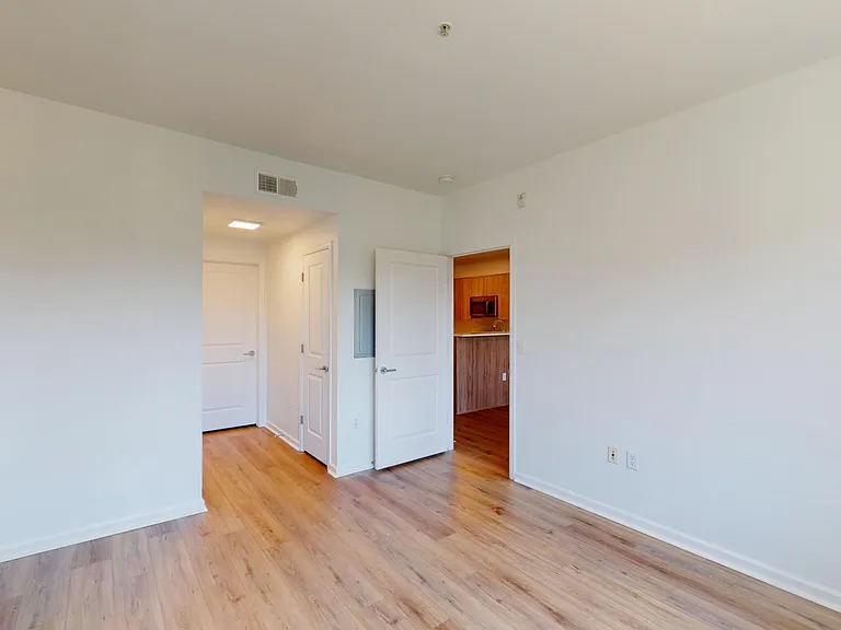 Spacious apartment Bedroom with Large Closet and Wood Style Flooring.