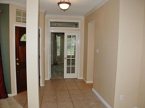 Entry foyer is spacious with dining on left and a large study behind the white French doors at the end of the hall.