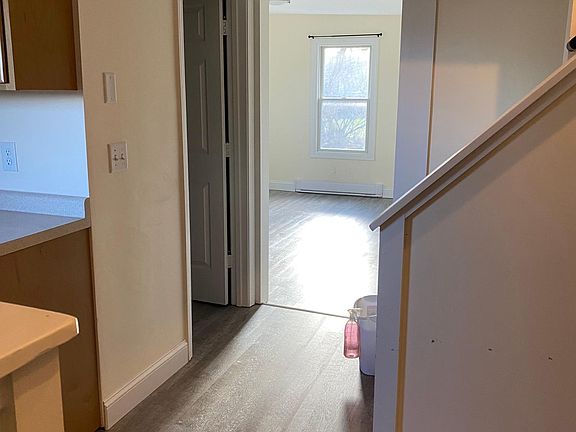 view from front door. kitchen to the left, entry area with washer/dryer to the right