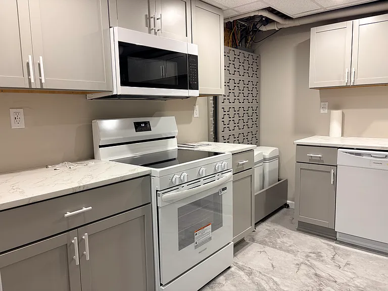 Full kitchen with electric range and microwave.