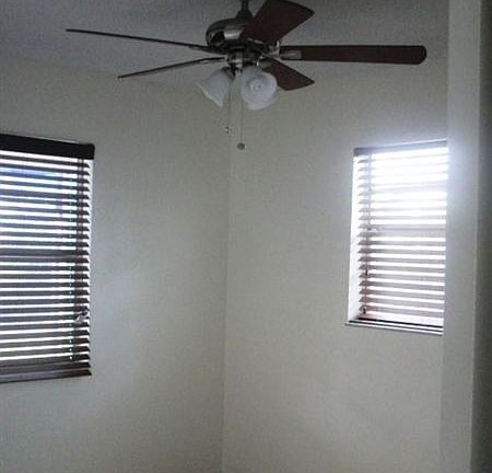 2nd bedroom with newly installed fan and new cherry blinds.