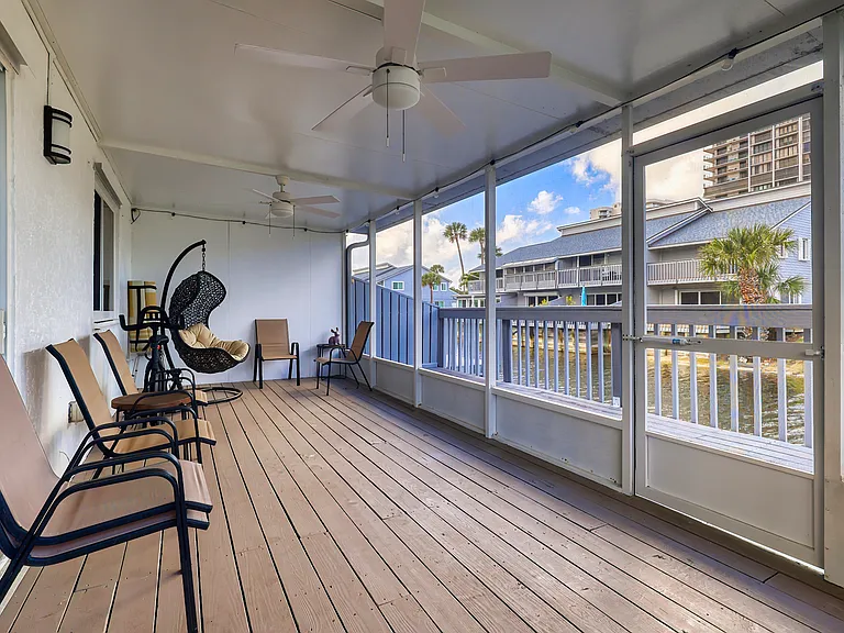 Enclosed lower level patio and private balcony with view of lake