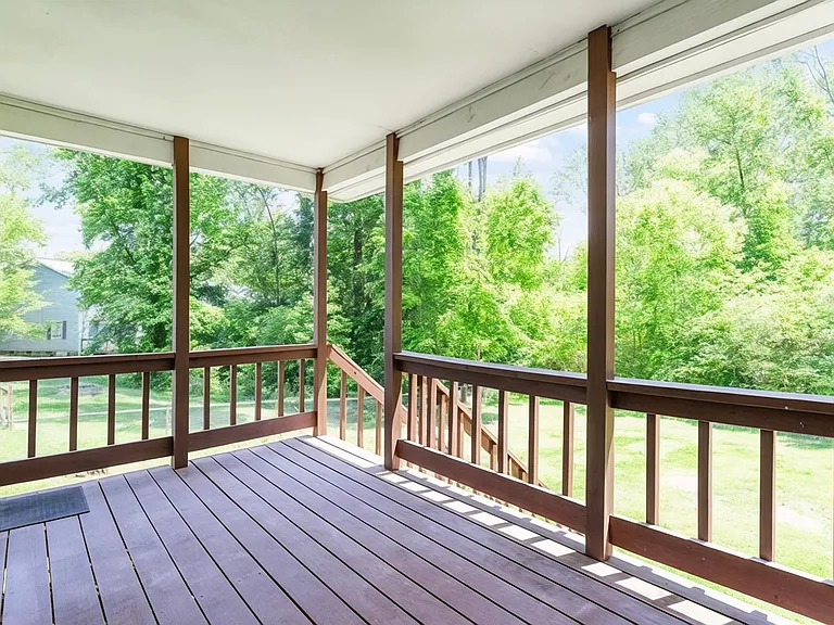 Private deck overlooking a spacious fenced yard_perfect for relaxing or entertaining.