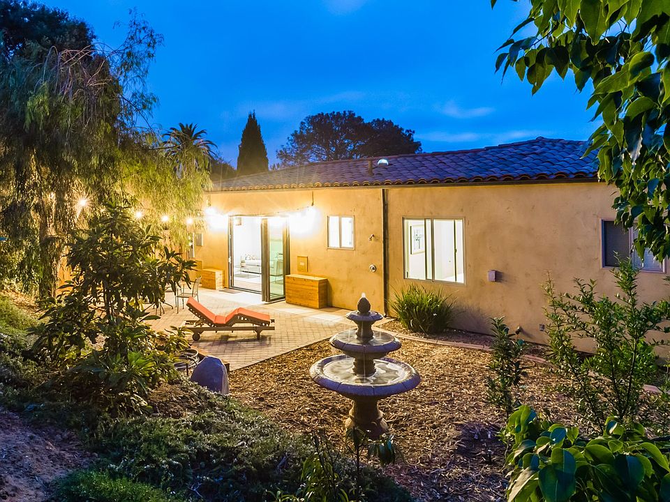 Large private gated yard with fountain, fruit trees, and open space.