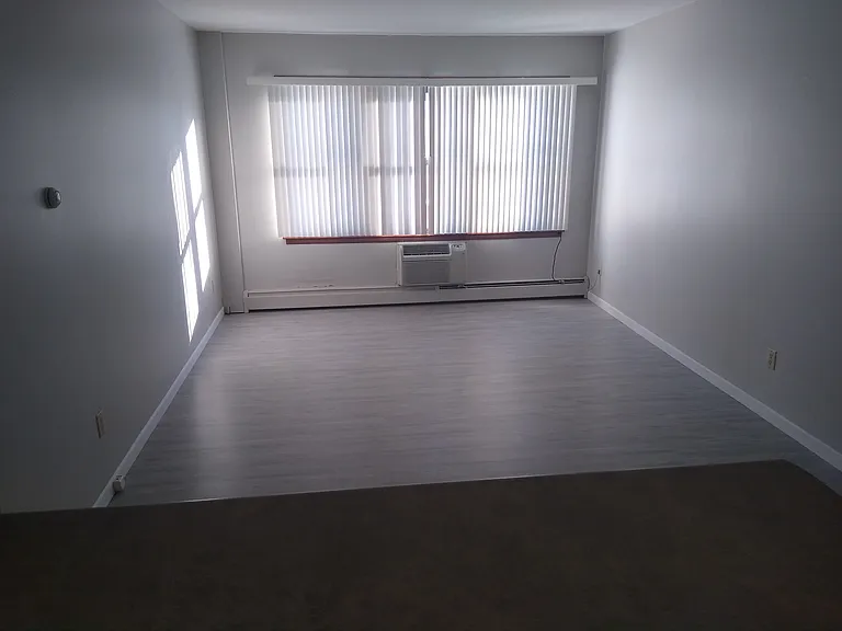 From the kitchen, looking at a sunlit living room over the convenient counter.