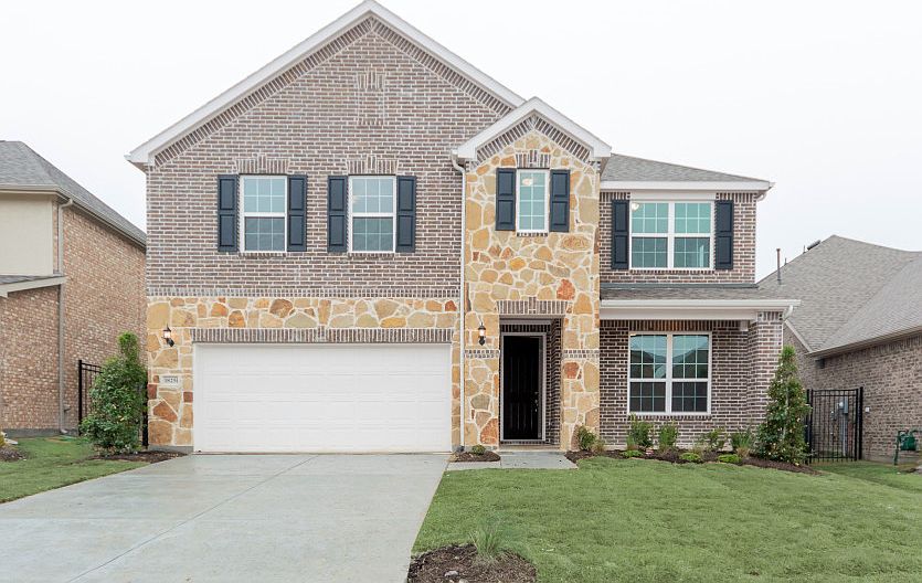 The Caldwell, a two-story home with covered front porch and 2-car garage, shown as Home Exterior B