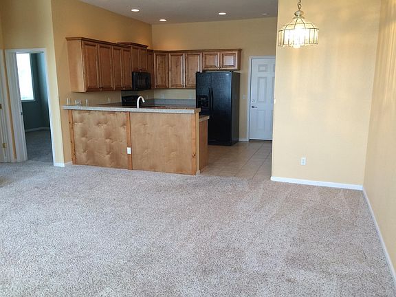View from the living room to the dining and Kitchen area. To the left of the picture are 2 bedrooms and bath.