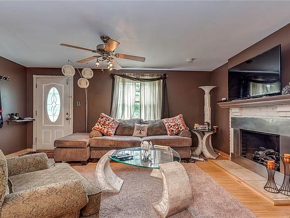 This view of the living room shows the entry with ceiling fan.