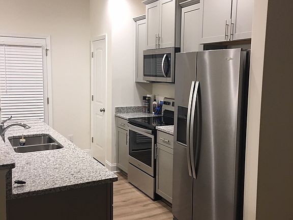 Kitchen with stainless appliances. Refrigerator is new. (Actual house)
