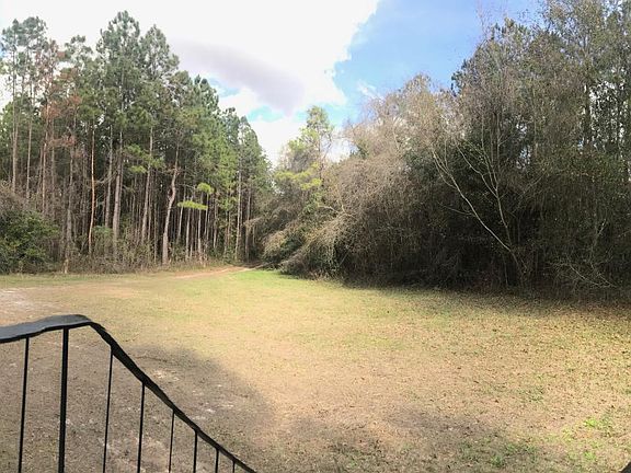 Looking at the front yard and driveway entrance from the front door.