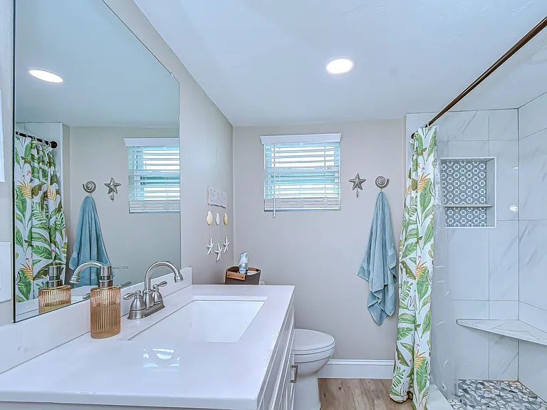 updated bathroom with a stand up shower