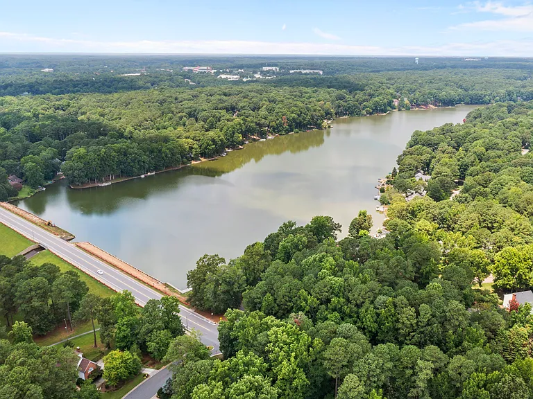 Nearby lake and wooded shoreline add to the peaceful neighborhood lifestyle.