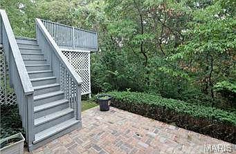 lovely brick patio overlooking serene wooded backsplash!