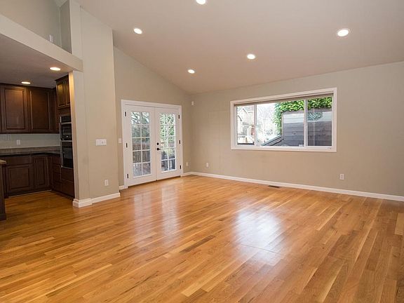 Living room and French doors onto newly updated deck Deck carpentry still occurring as of 8/28