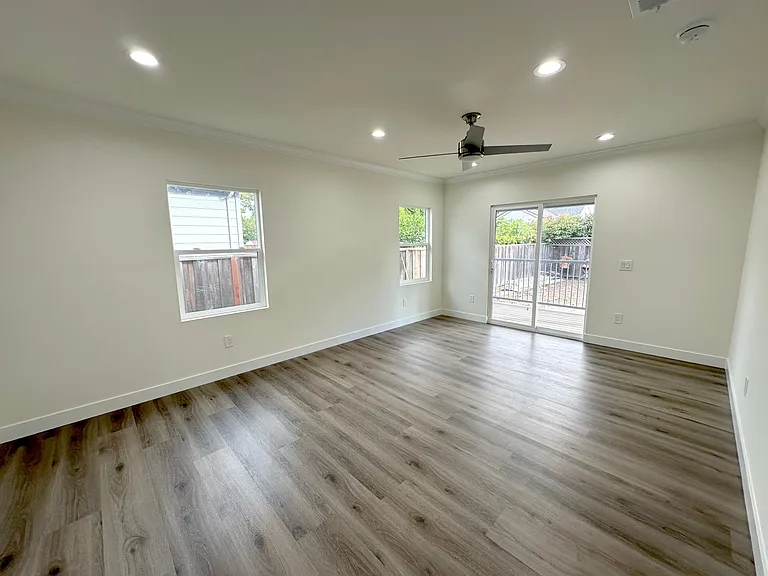spacious master bedroom off of the main living room with option for wall mount TV and patio door for natural light